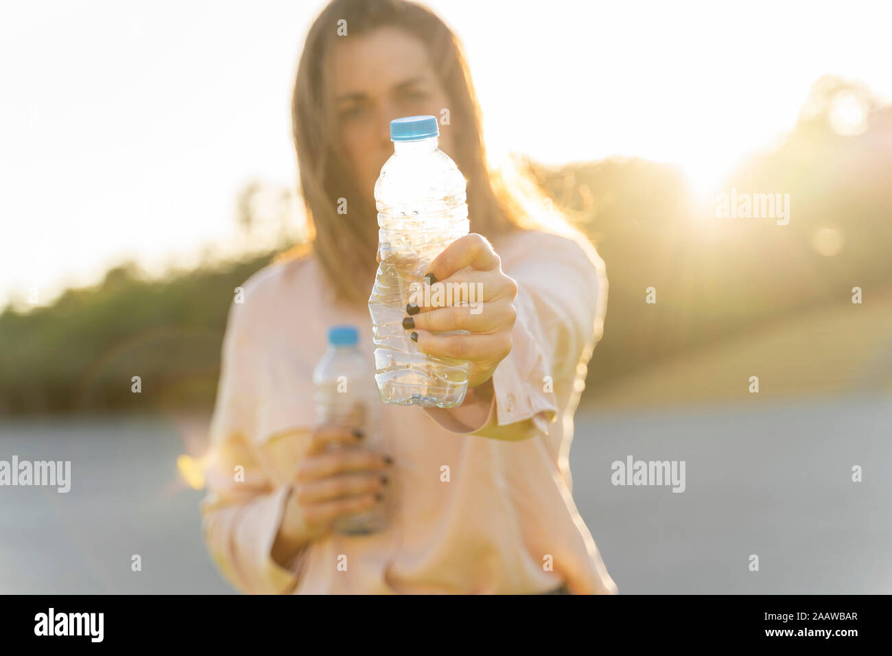 Woman's hand holding empty plastic bottle Stock Photo
