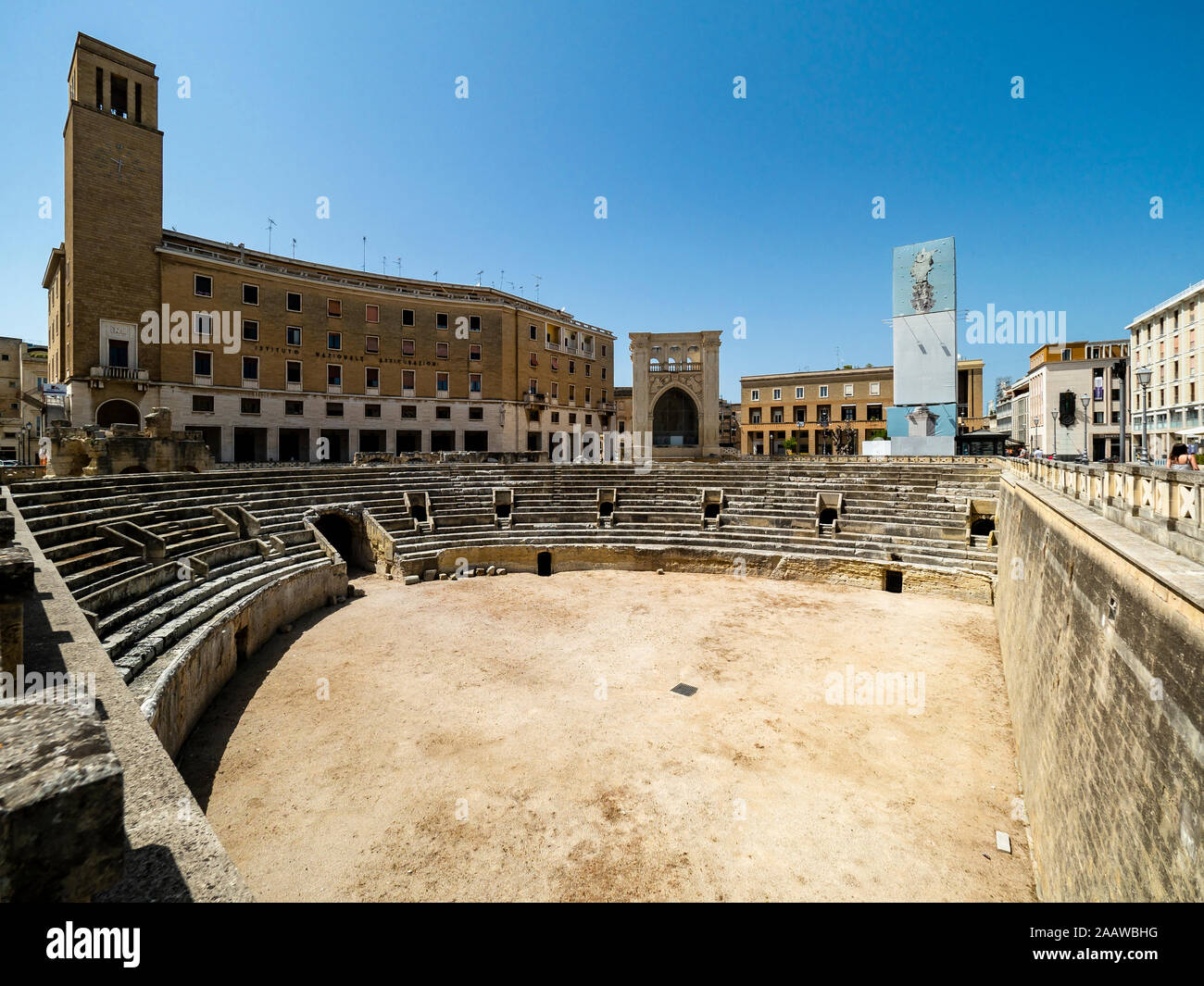 Roman amphitheater against clear blue sky in Altstadt during sunny day, Lecce, Italy Stock Photo