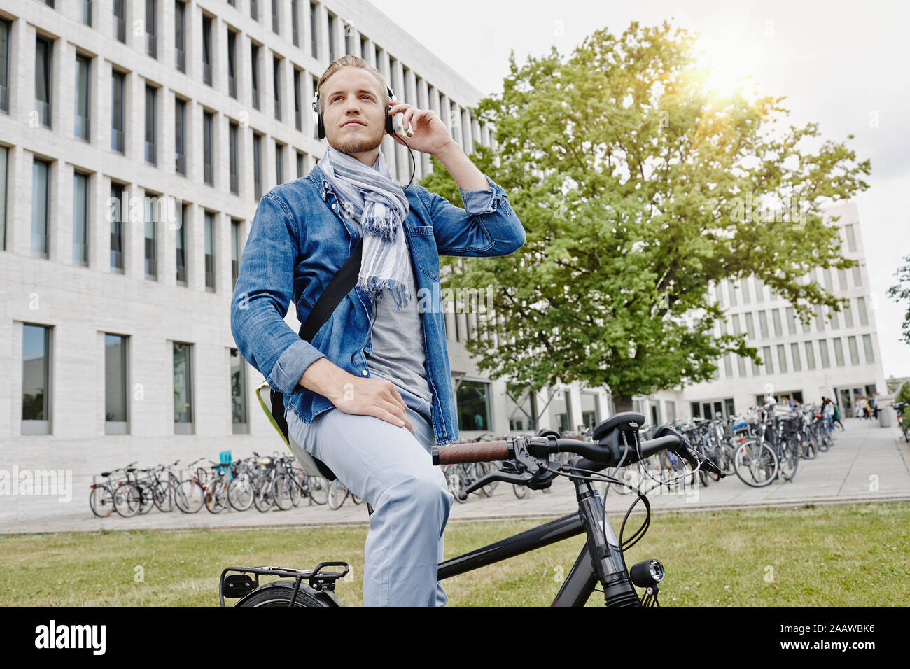 Student with headphones and e-bike Stock Photo