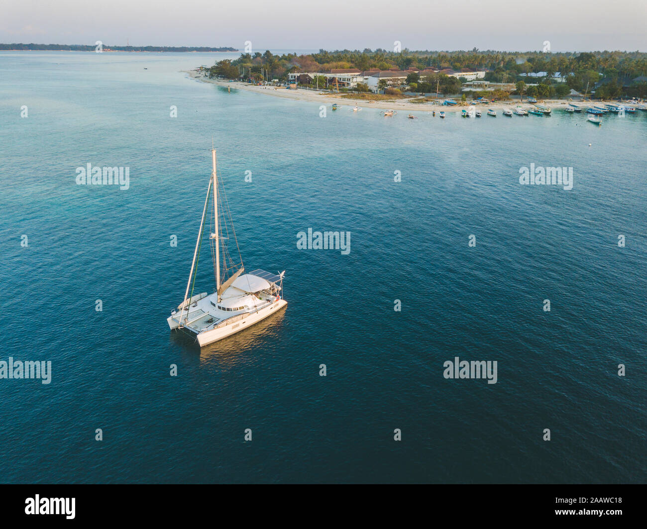 Drone shot of catamaran on sea at Gili-Air Island against clear sky ...