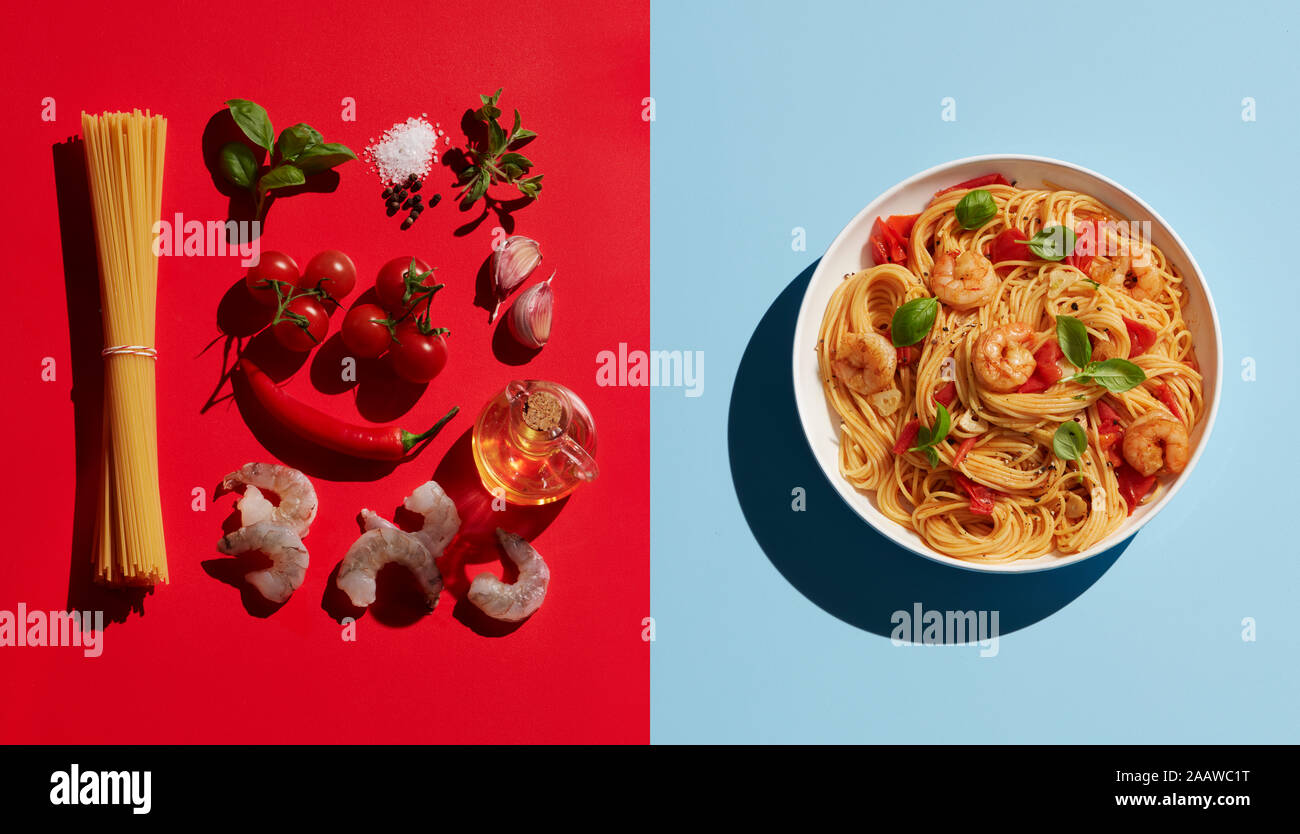 Directly above shot of shrimp pasta by ingredients on colored background Stock Photo
