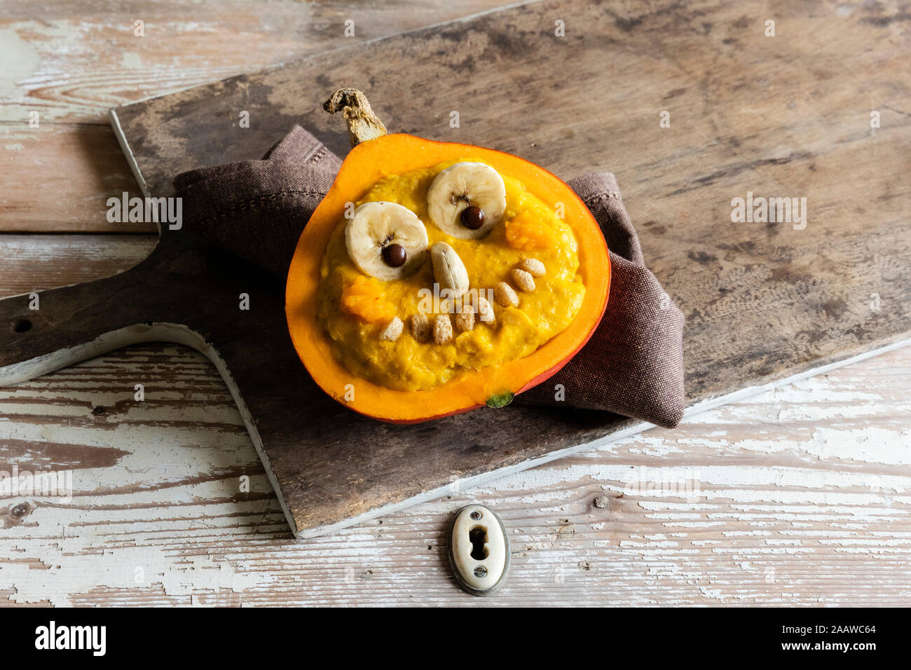 High angle view of pumpkin with anthropomorphic face on tray during Halloween Stock Photo