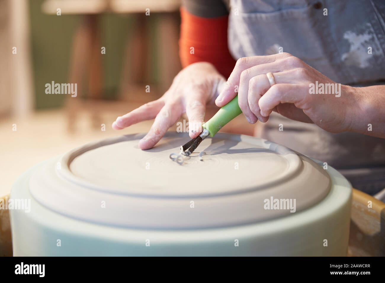 Woman working with a pottery wheel in her workshop Stock Photo