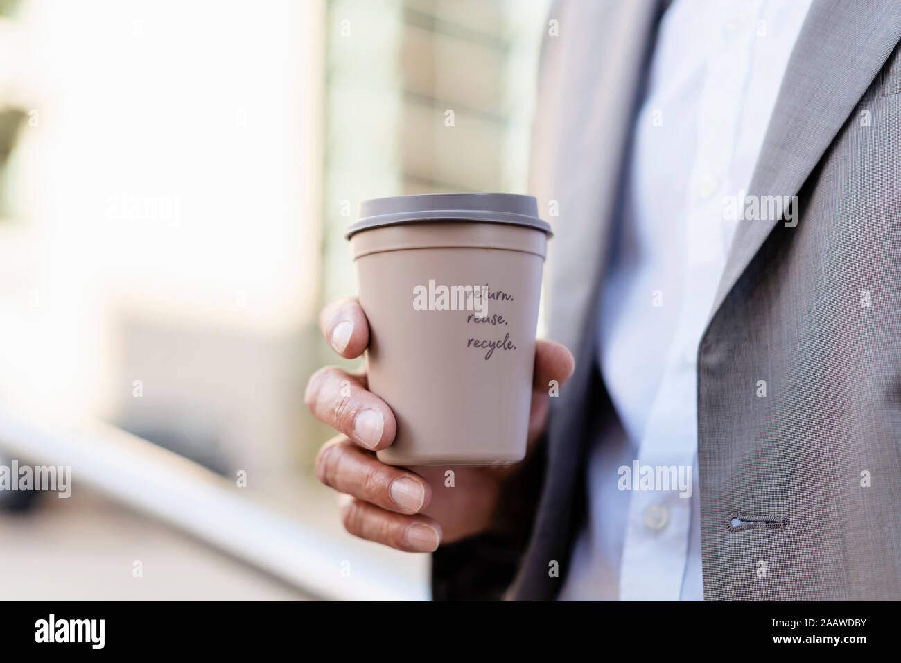 Close-up of businessman holding reusable takeaway coffee cup Stock Photo