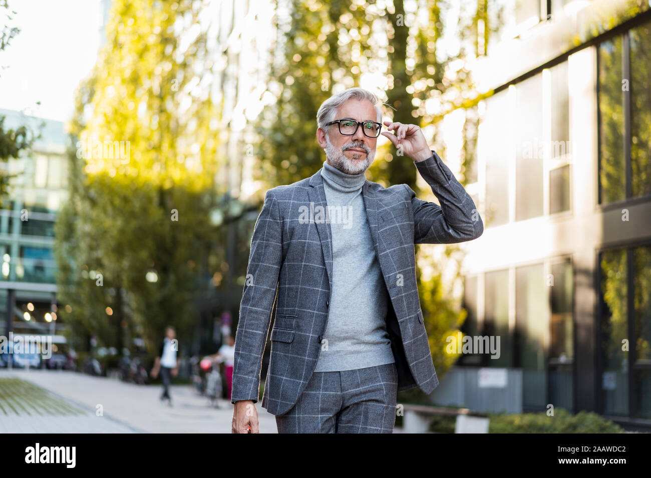 Fashionable mature businessman on the go in the city Stock Photo