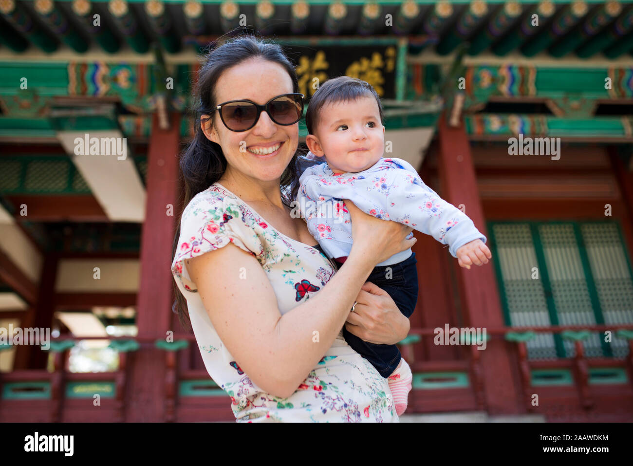 Portrait of happy mother with baby girl on her arm, Seoul, South Korea Stock Photo