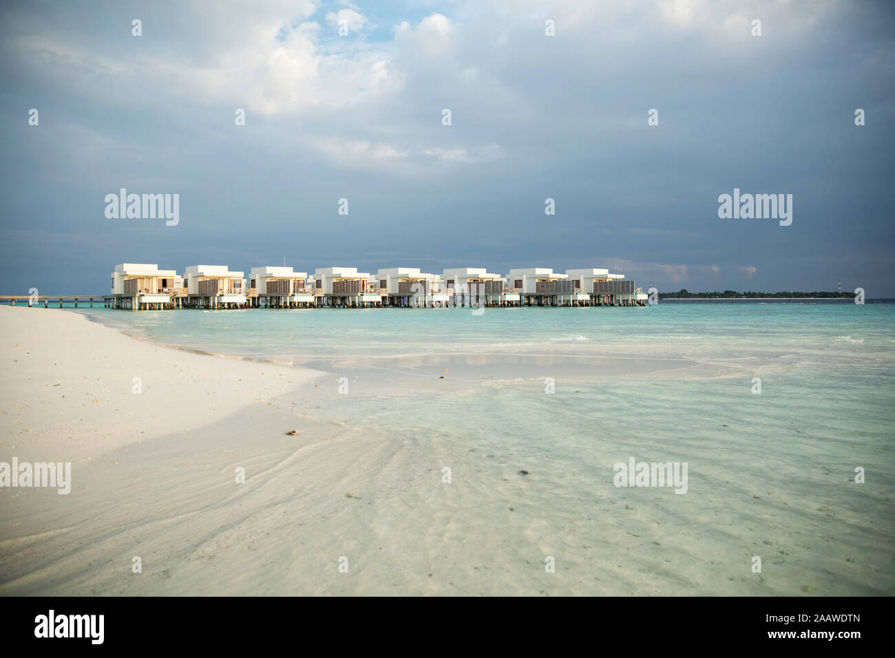 View of villas over sea against cloudy sky at Maldives Stock Photo