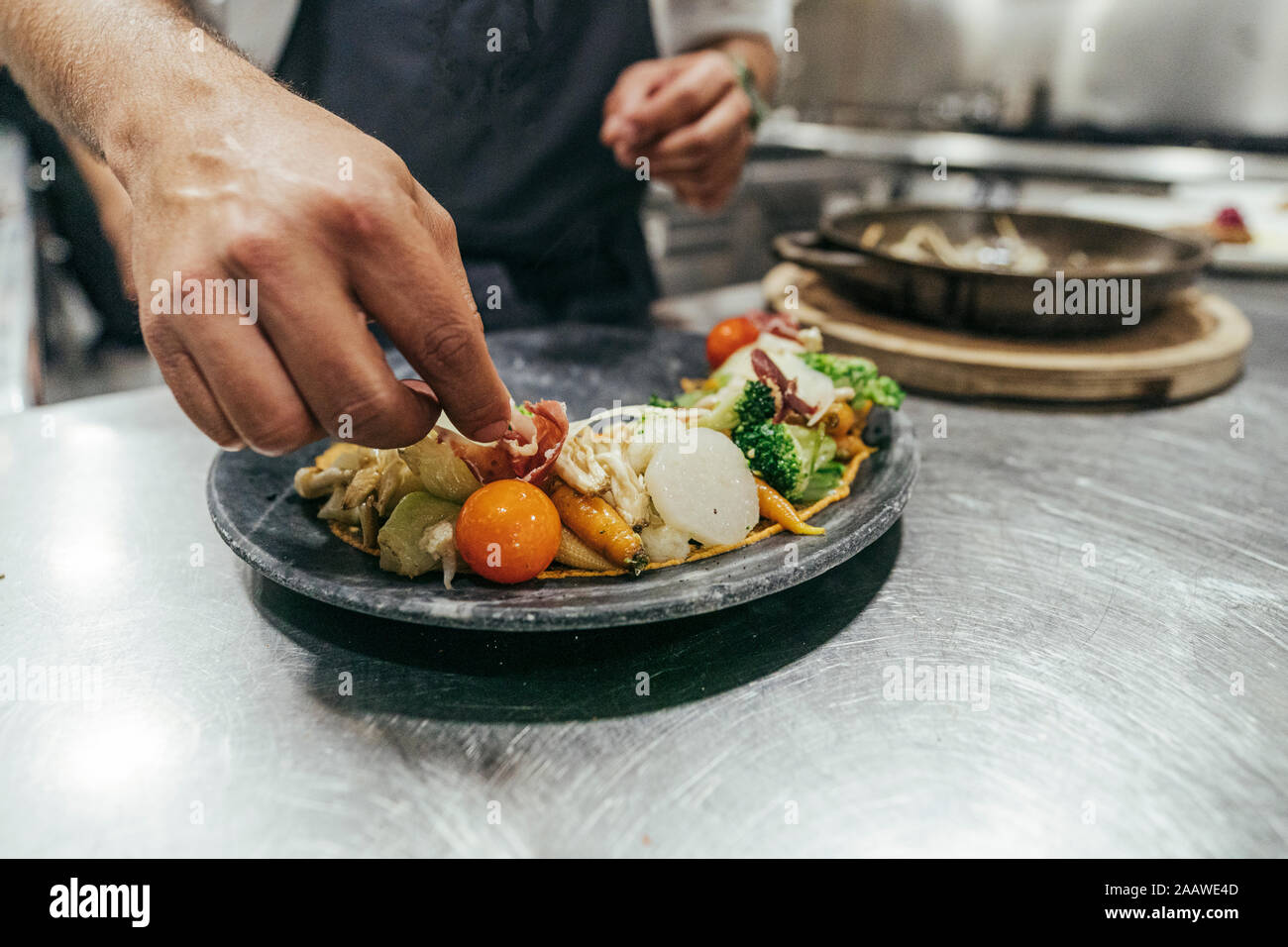 Chef garnishing plate with food Stock Photo