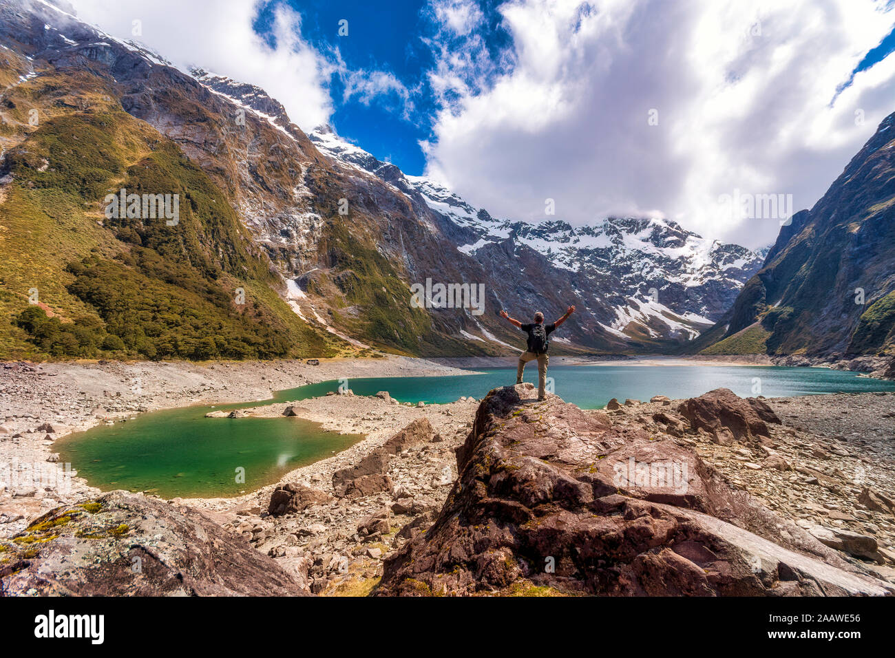 Hiker looking to Lake Marian, Fiordland National Park, South Island, New Zealand Stock Photo