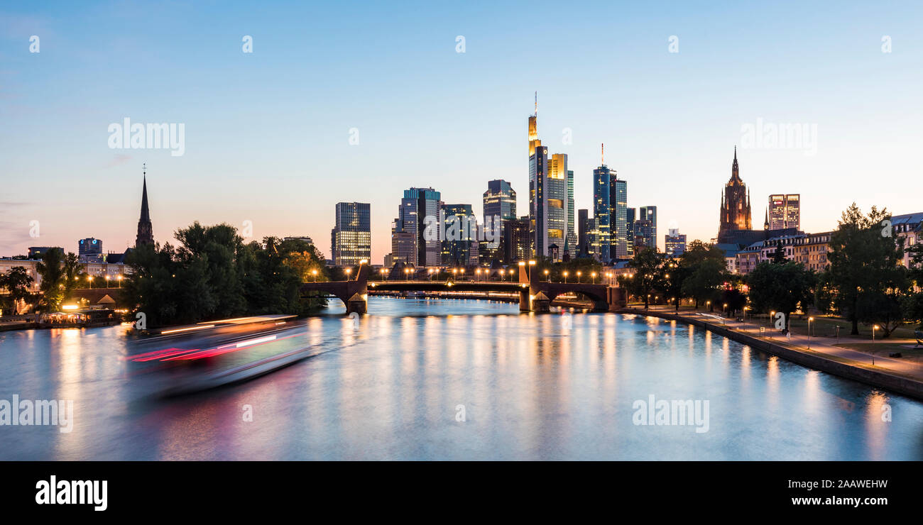 Blurred motion of tourboat on river against clear sky at dusk in Frankfurt, Germany Stock Photo