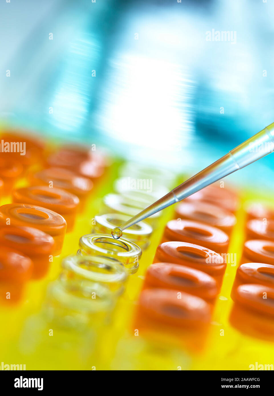 Close-up of samples being poured from pipette in vials for analytical testing at laboratory Stock Photo