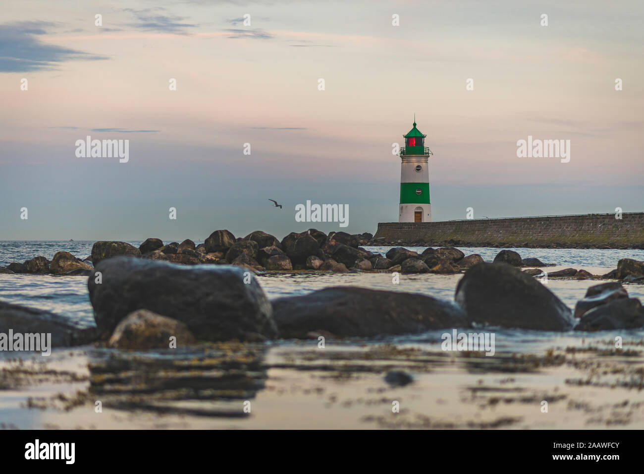 Germany, Schleswig-Holstein, Schleimunde lighthouse seen from coast at dusk Stock Photo