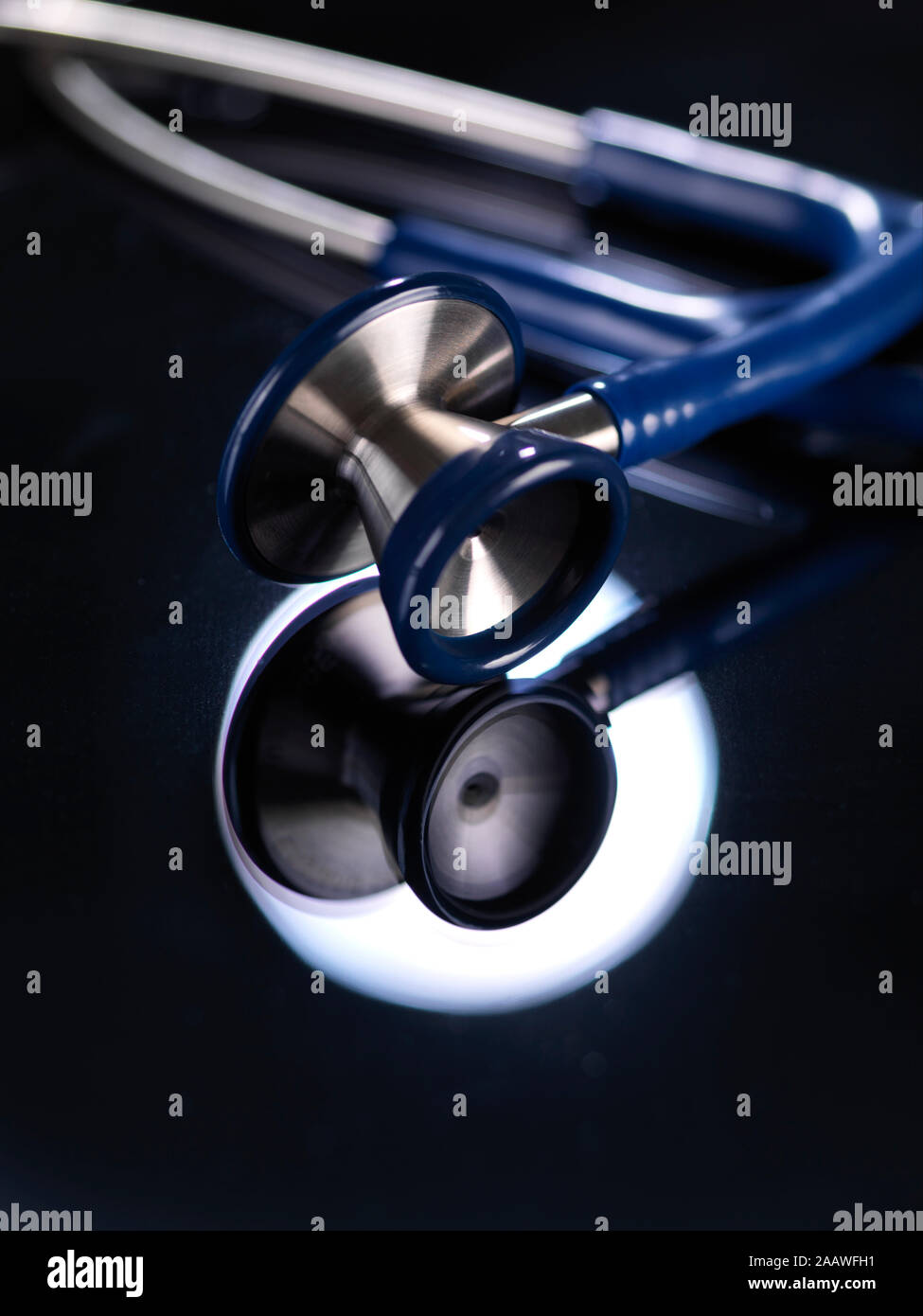 Close-up of stethoscope reflecting on table in hospital Stock Photo