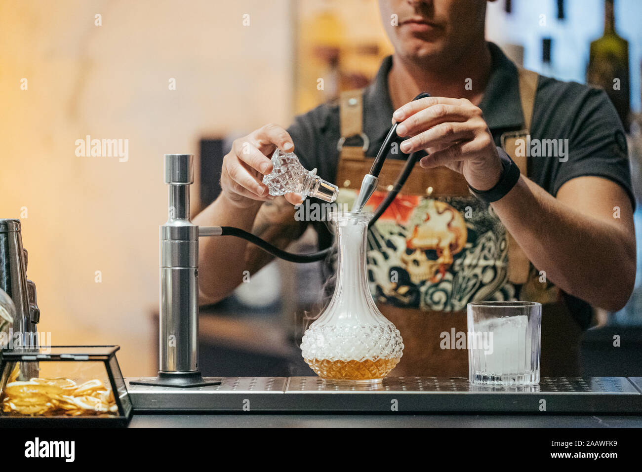Bartender mixing cocktail in a bar, decanter with steam Stock Photo Alamy