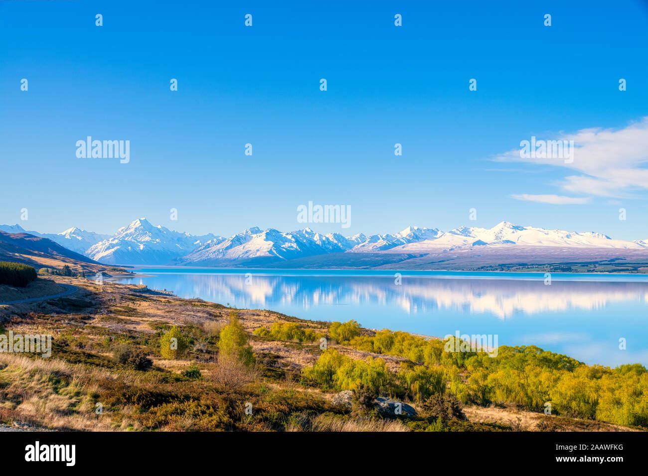 New Zealand, South Island, Scenic view of shore of Lake Pukaki with snowcapped mountains in background Stock Photo