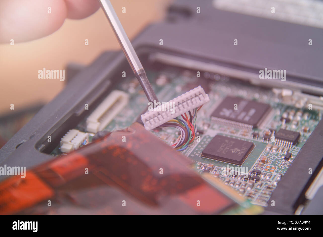 Computer service. Man repairing notebook at the table Stock Photo