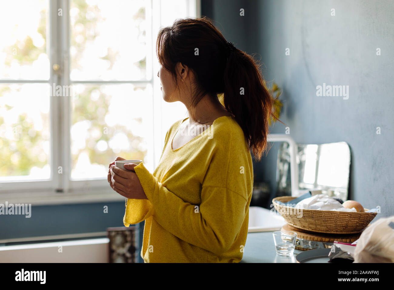woman drinking tea in office kitchenet Stock Photo