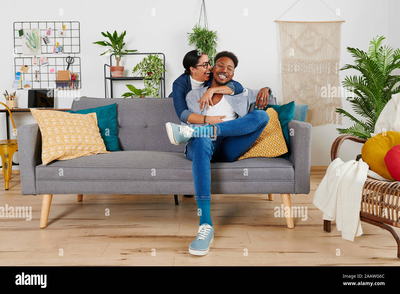 Multiethnic couple spending time together at living room Stock Photo