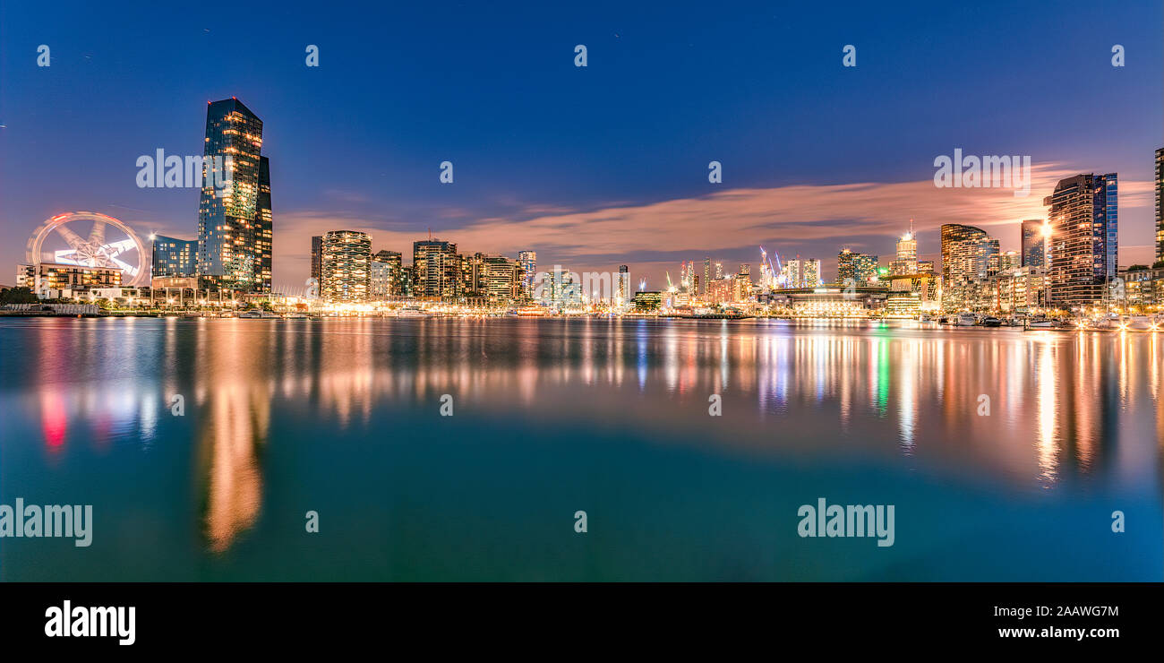 Illuminated buildings in front of Yarra River at Melbourne, Australia Stock Photo