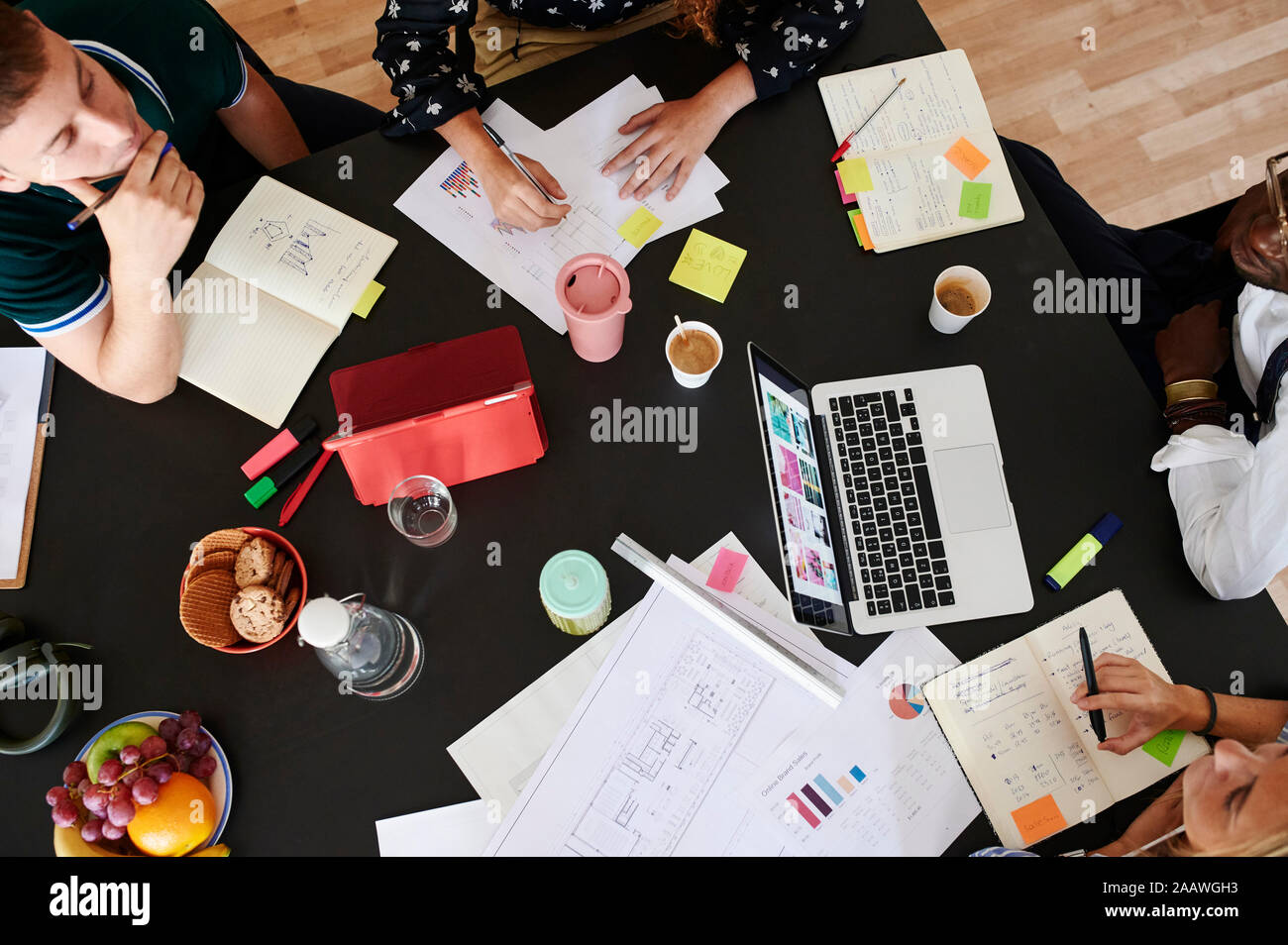 Close-up of young business people having a meeting in office Stock Photo