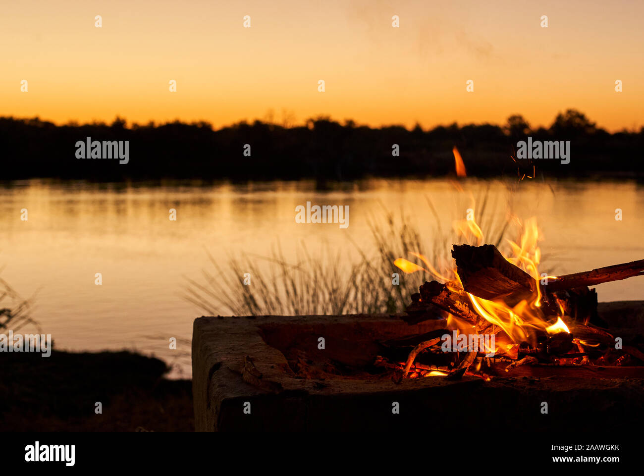 Bonfire at riverbank during sunset at Caprivi Strip, Namibia Stock Photo