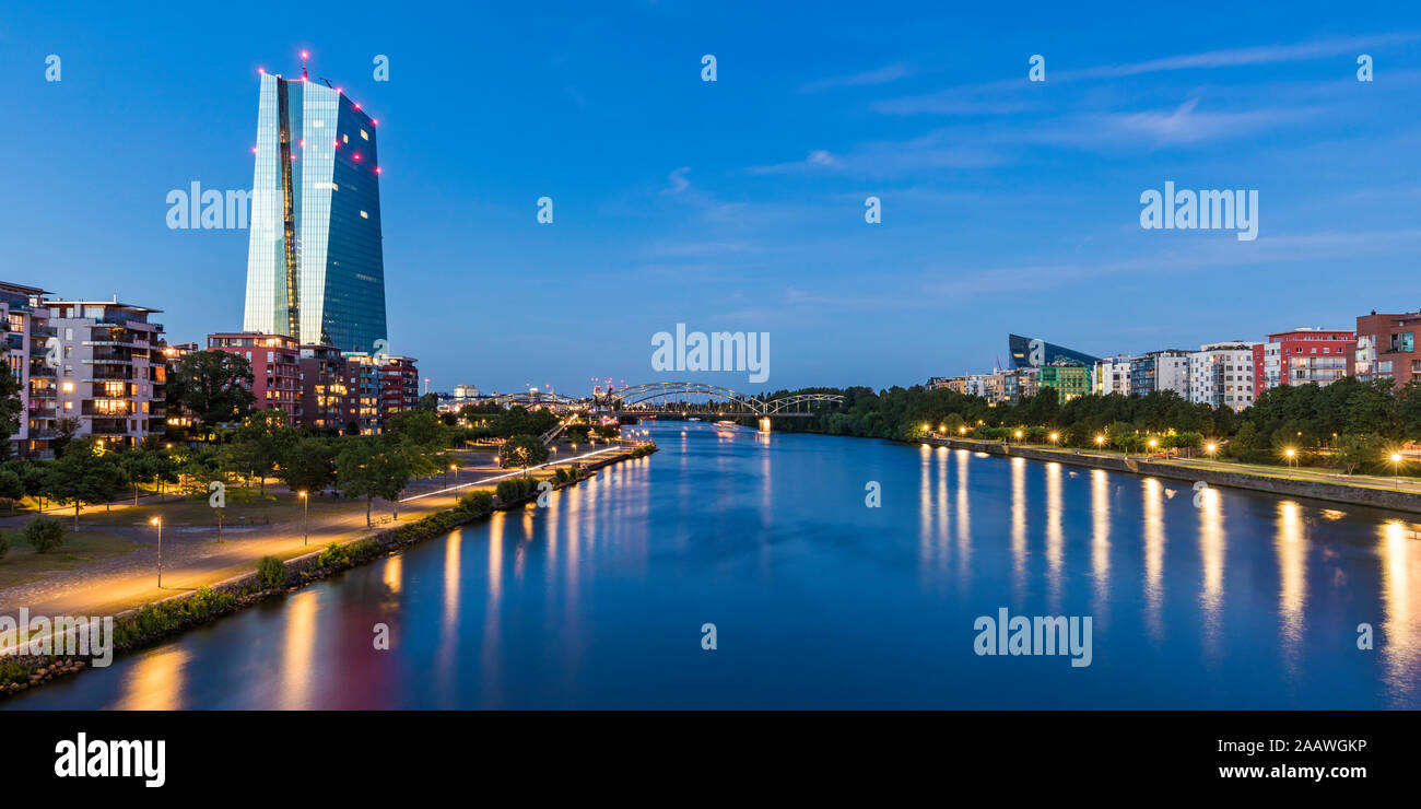 River amidst illuminated buildings at night in Frankfurt, Germany Stock Photo