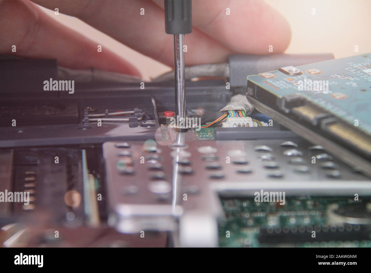 Computer service. Man repairing notebook at the table Stock Photo