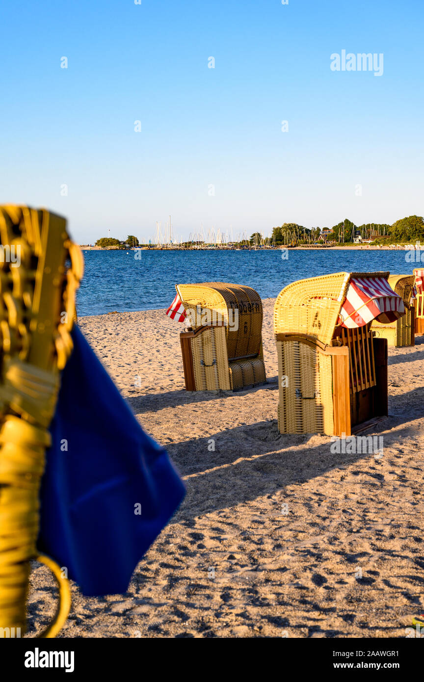 Germany, Schleswig-Holstein, Niendorf, Strandkorb beach-chairs on sandy coastal beach Stock Photo