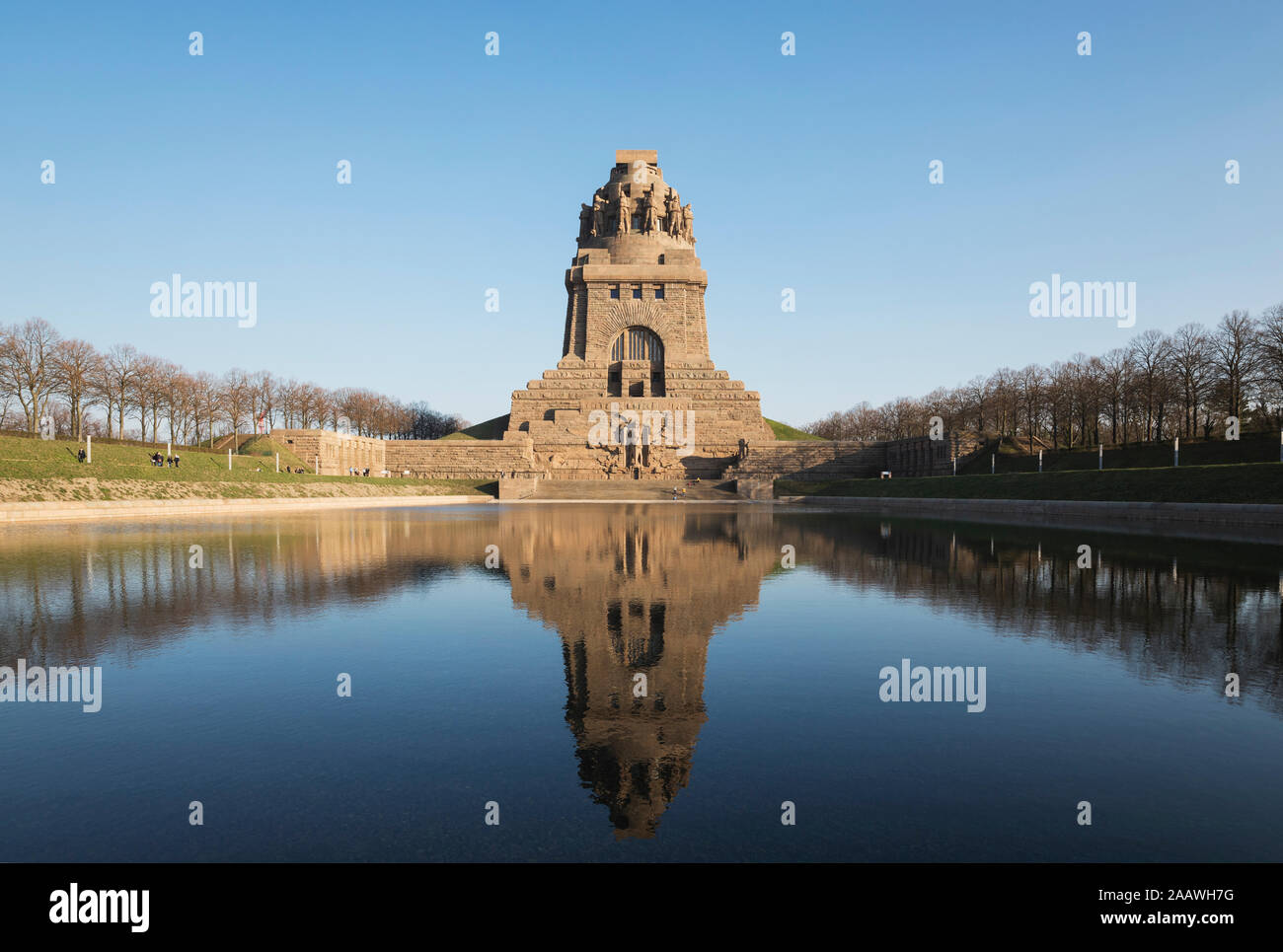 Lake of tears with reflection of Völkerschlachtdenkmal against clear blue sky, Saxony, Germany Stock Photo