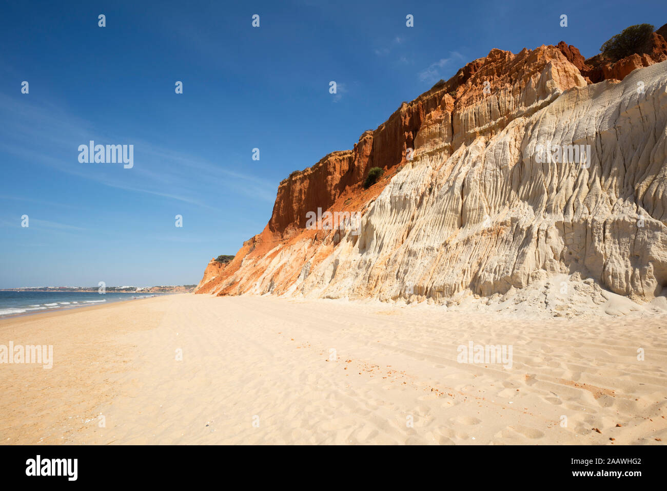 Rocky sandstone coast against sky at Algarve, Portugal Stock Photo