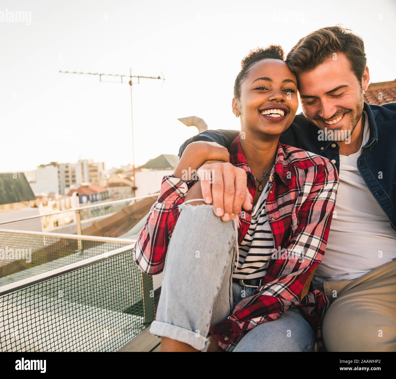 Happy young man sitting balcony hi-res stock photography and images - Alamy