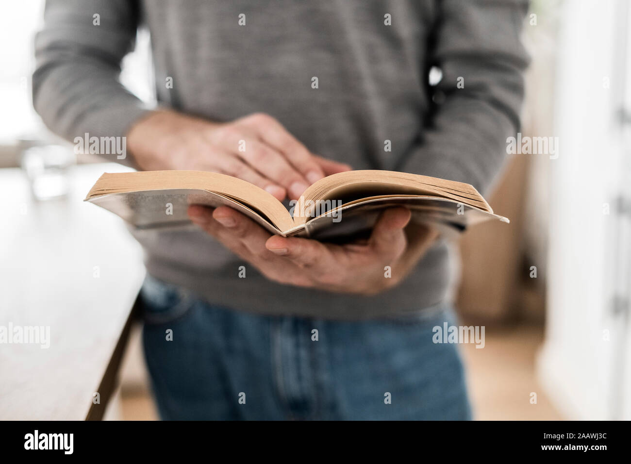 Close-up of man reading book at home Stock Photo