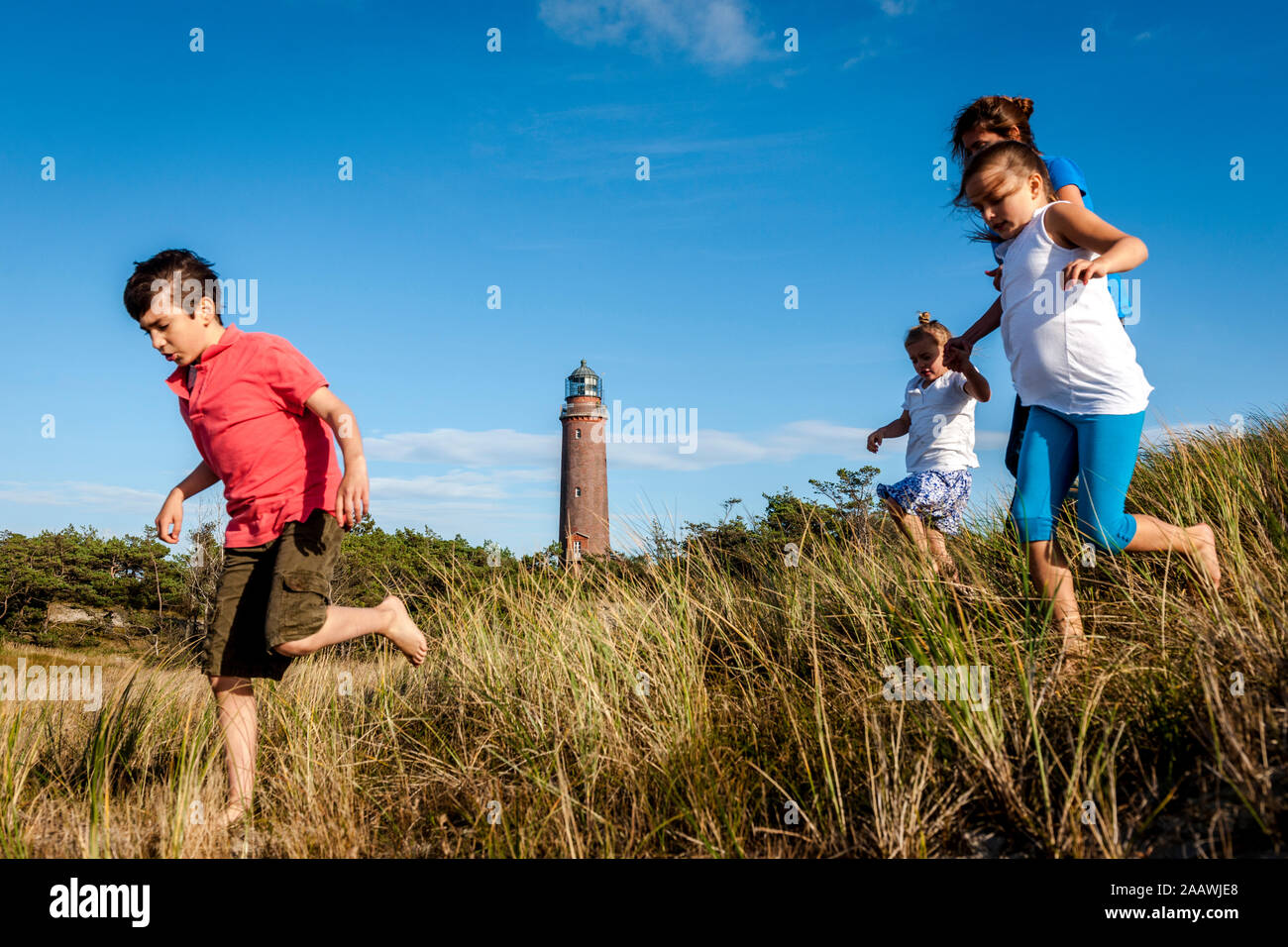 Family running in a beach dune, Darss, Mecklenburg-Western Pomerania, Germany Stock Photo