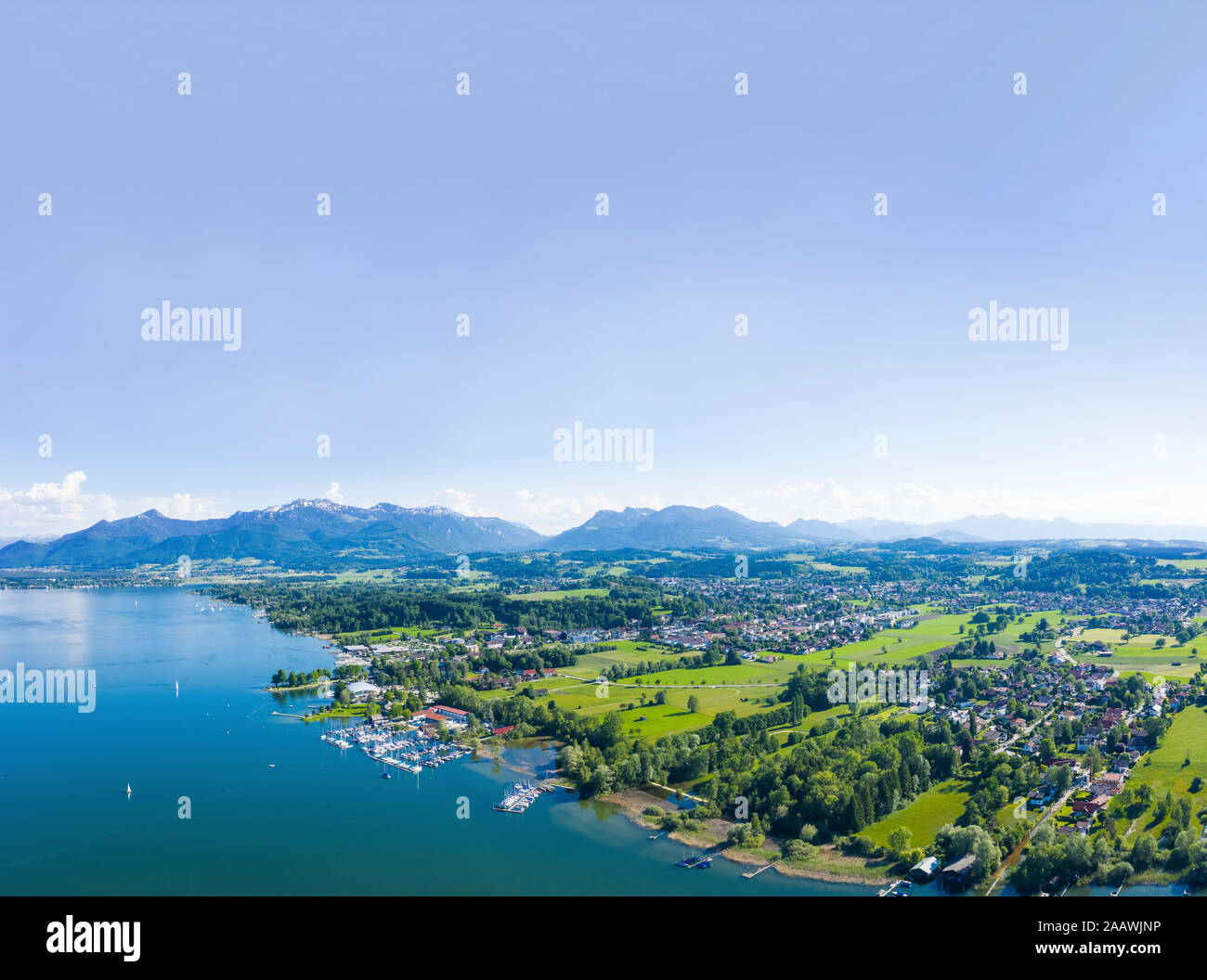 Germany, Bavaria, Prien am Chiemsee, Sky over coastal town with Chiemgau Alps in background Stock Photo