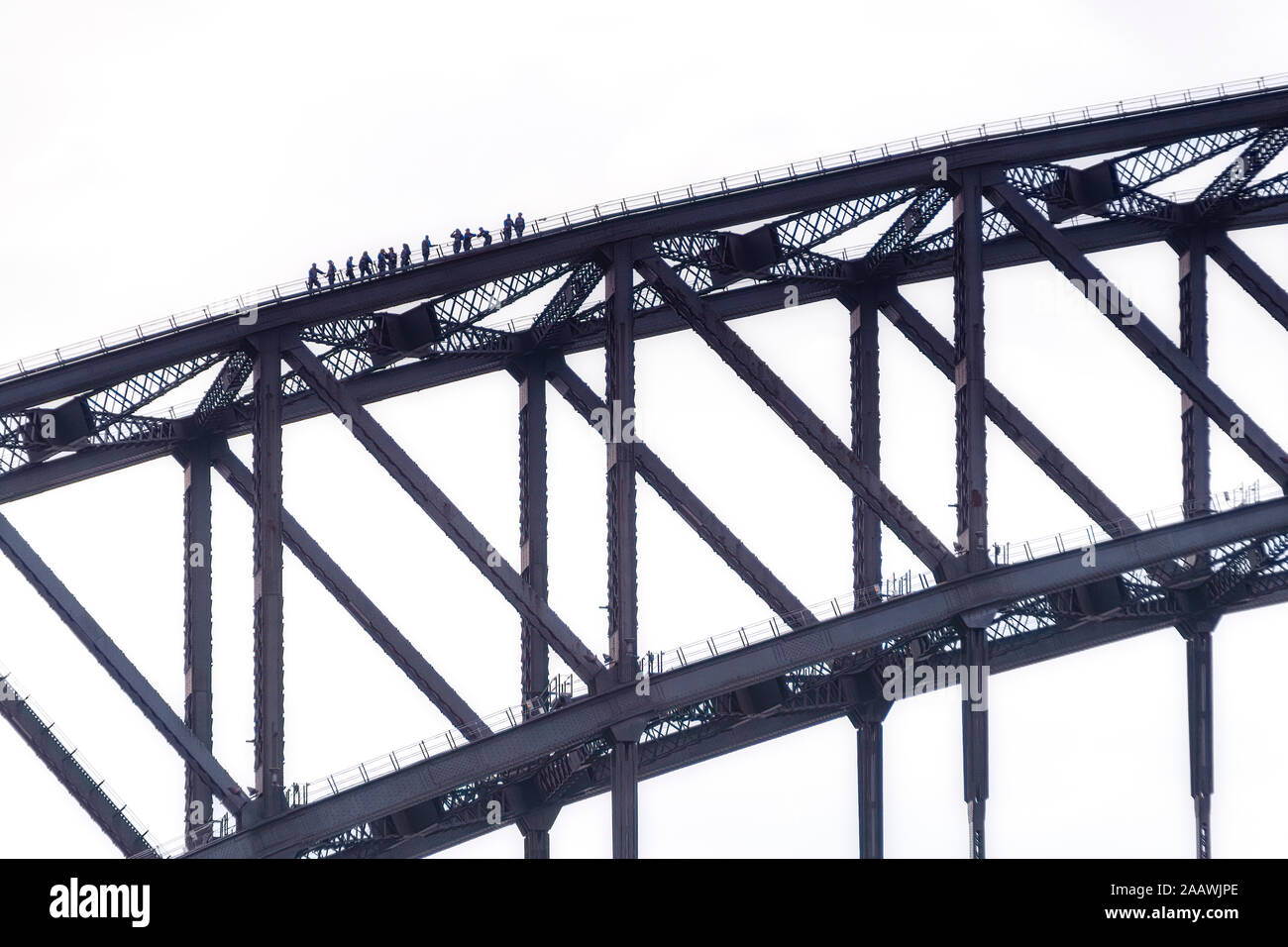 Silhouette people climbing Sydney Bridge against clear sky, Australia Stock Photo