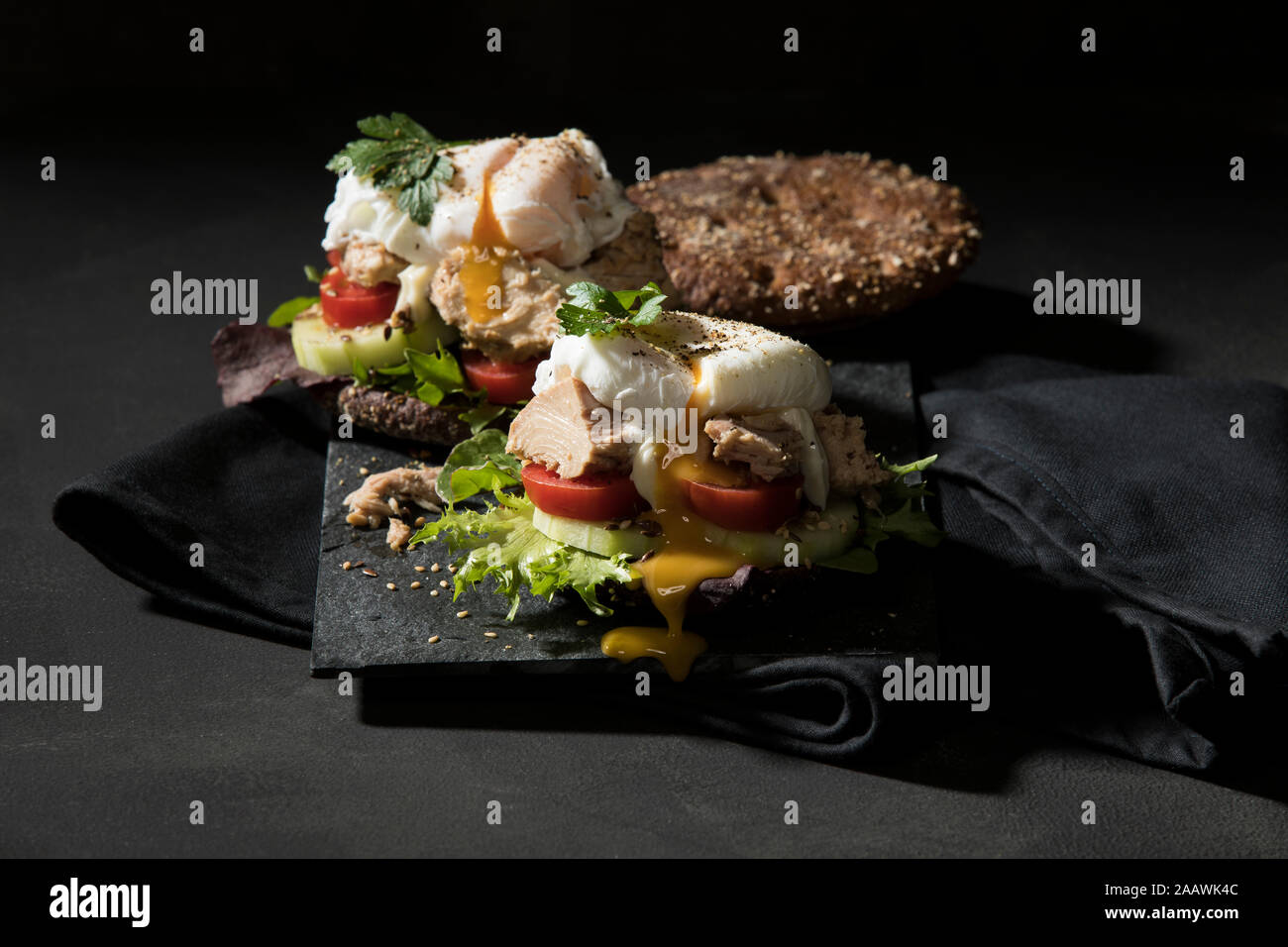 Close-up of open faced sandwich served on table against black background Stock Photo
