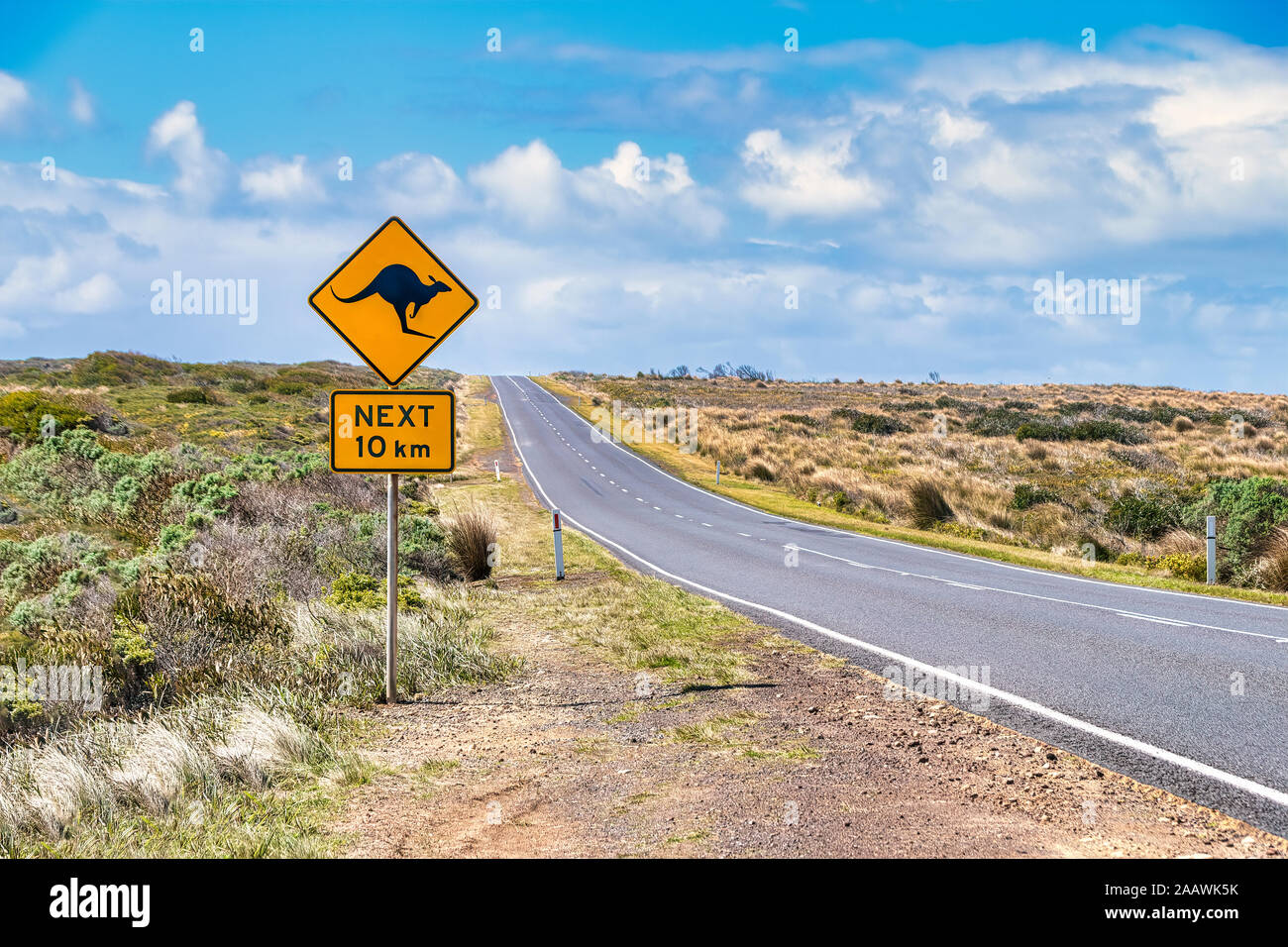 Kangaroo crossing sign by Great Ocean Road against sky, Victoria, Australia Stock Photo