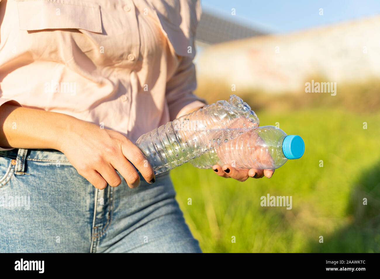 Woman's hands holding empty plastic bottles, close-up Stock Photo