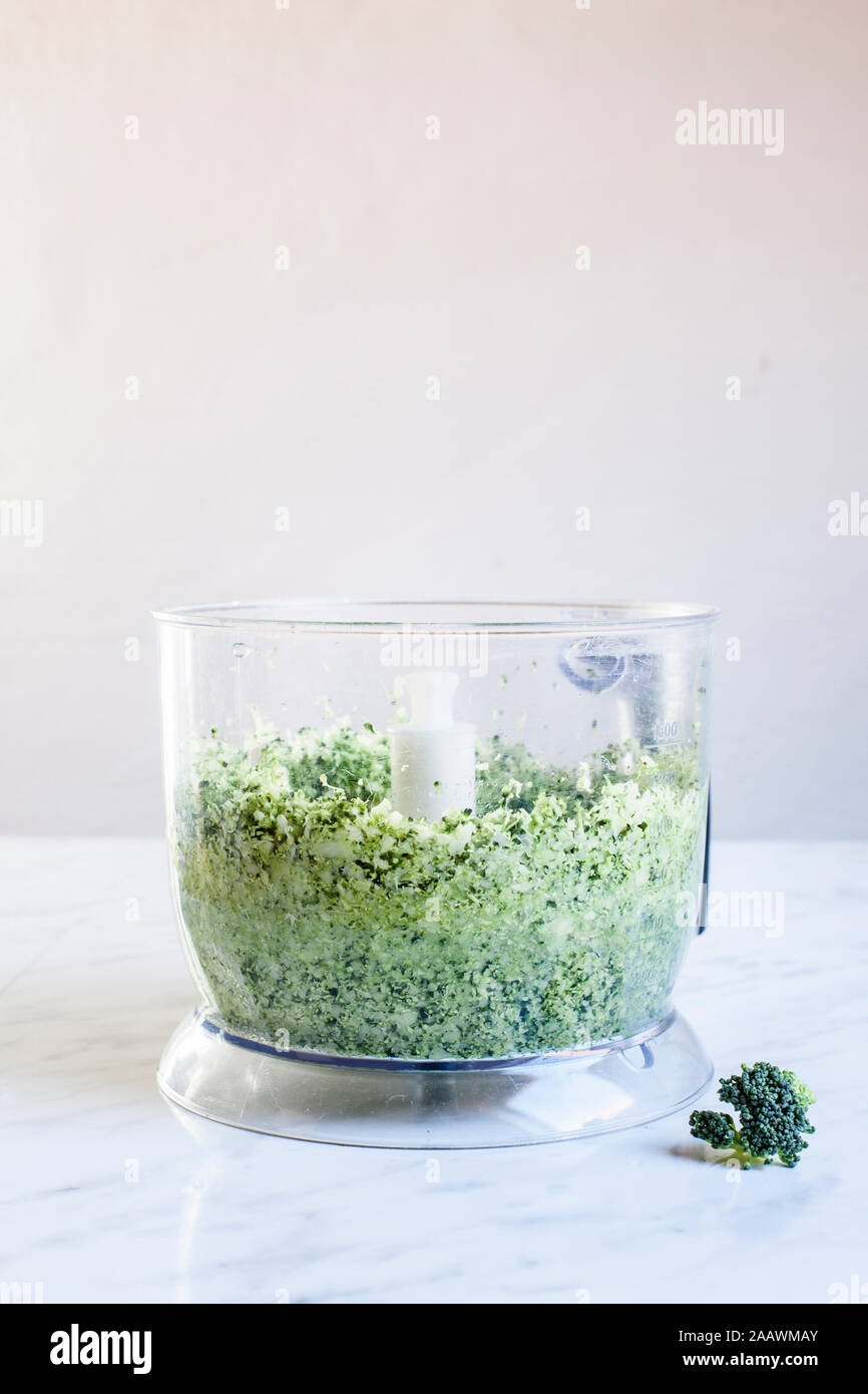Shredded broccoli (broccoli rice) in a food processor Stock Photo