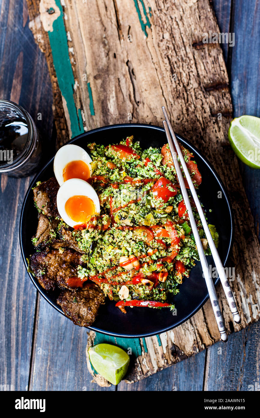 Thai style fried broccoli rice (shredded broccoli) with beef slices, eggs, and spicy sauce
