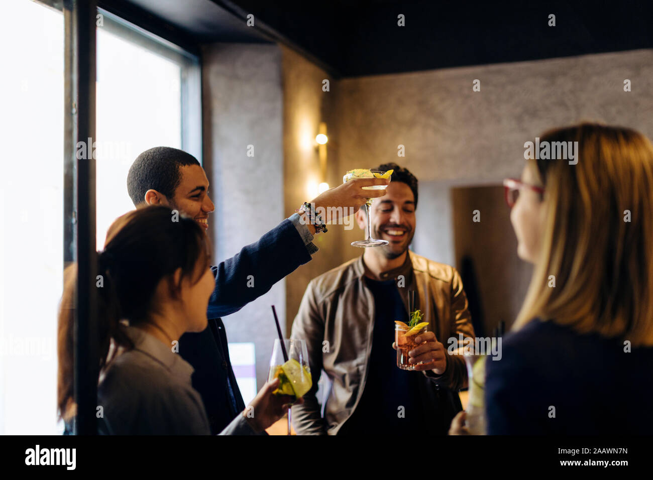 Colleagues celebrating after work in a bar Stock Photo