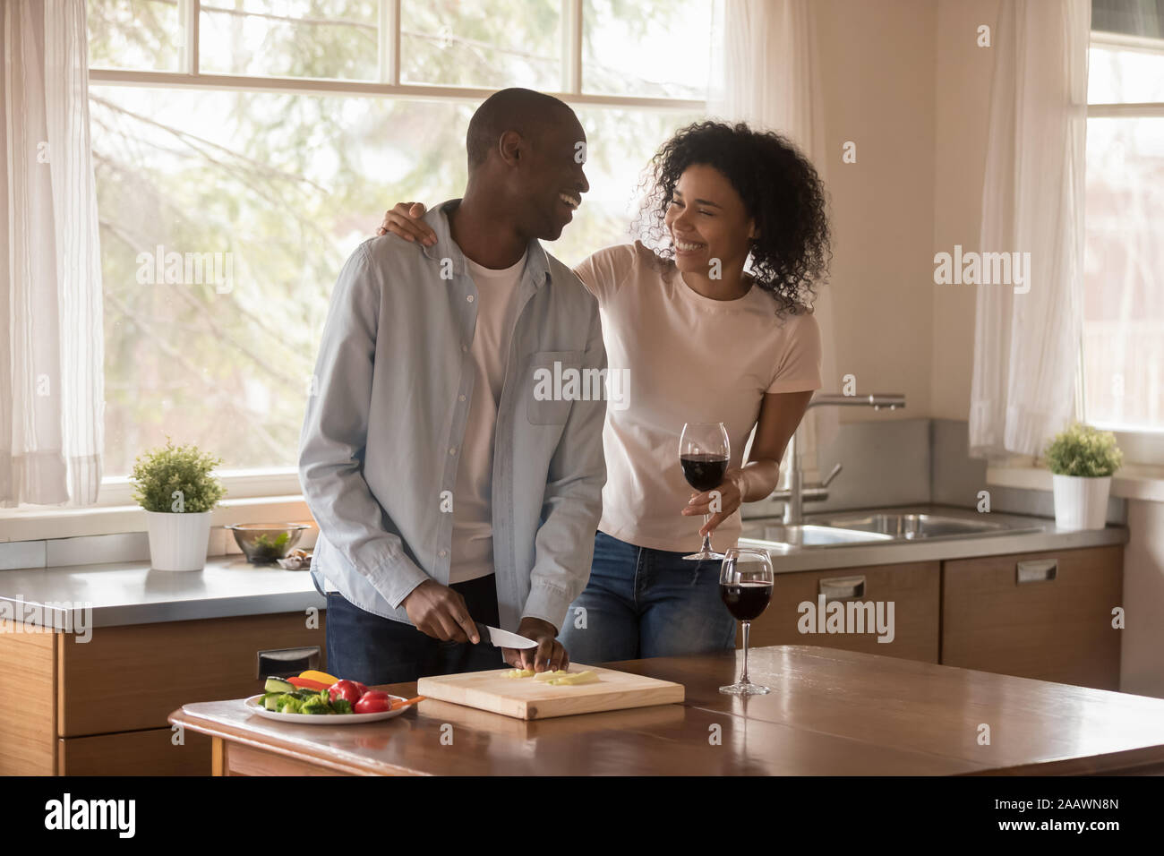 Happy biracial couple have fun cooking together in kitchen Stock Photo ...