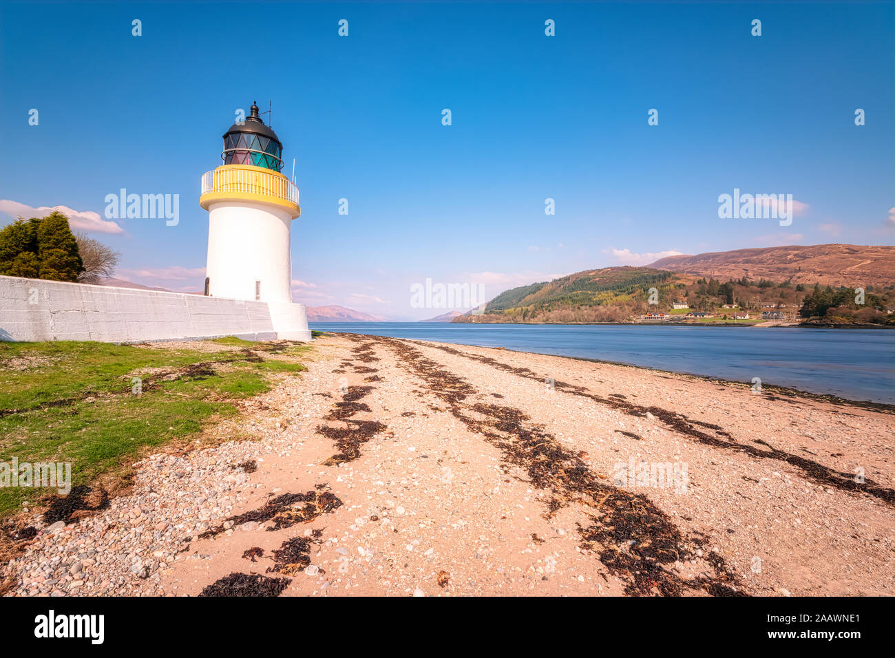 Corran Lighthouse by Loch Linnhe against blue sky, Highlands, Scotland, UK Stock Photo
