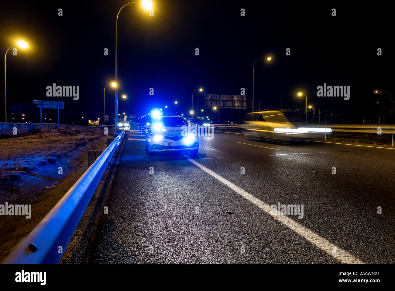 Illuminated police car on road of Madrid during night Stock Photo