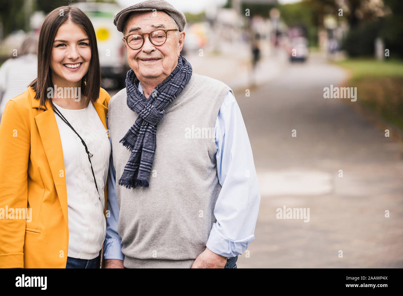 Portrait of senior man side by side with his adult granddaughter Stock Photo