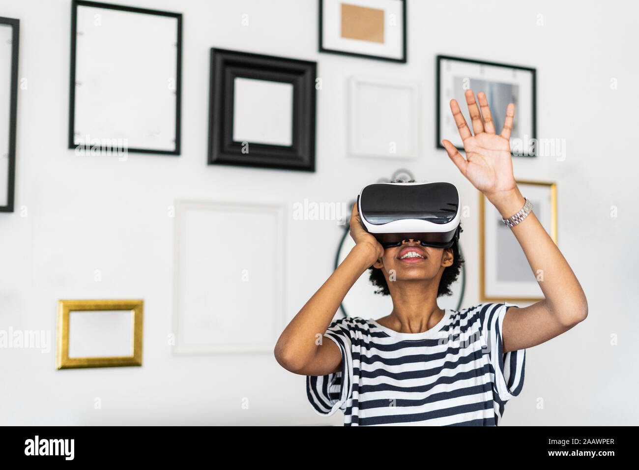 Young woman with VR glasses at home Stock Photo - Alamy