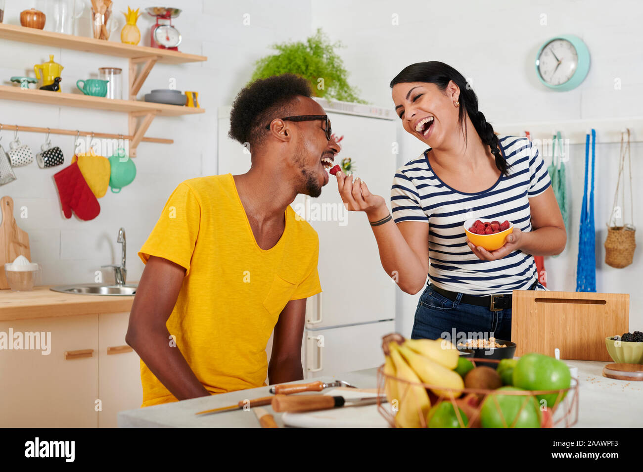 Multiethnic couple breakfasting together in the kitchen Stock Photo
