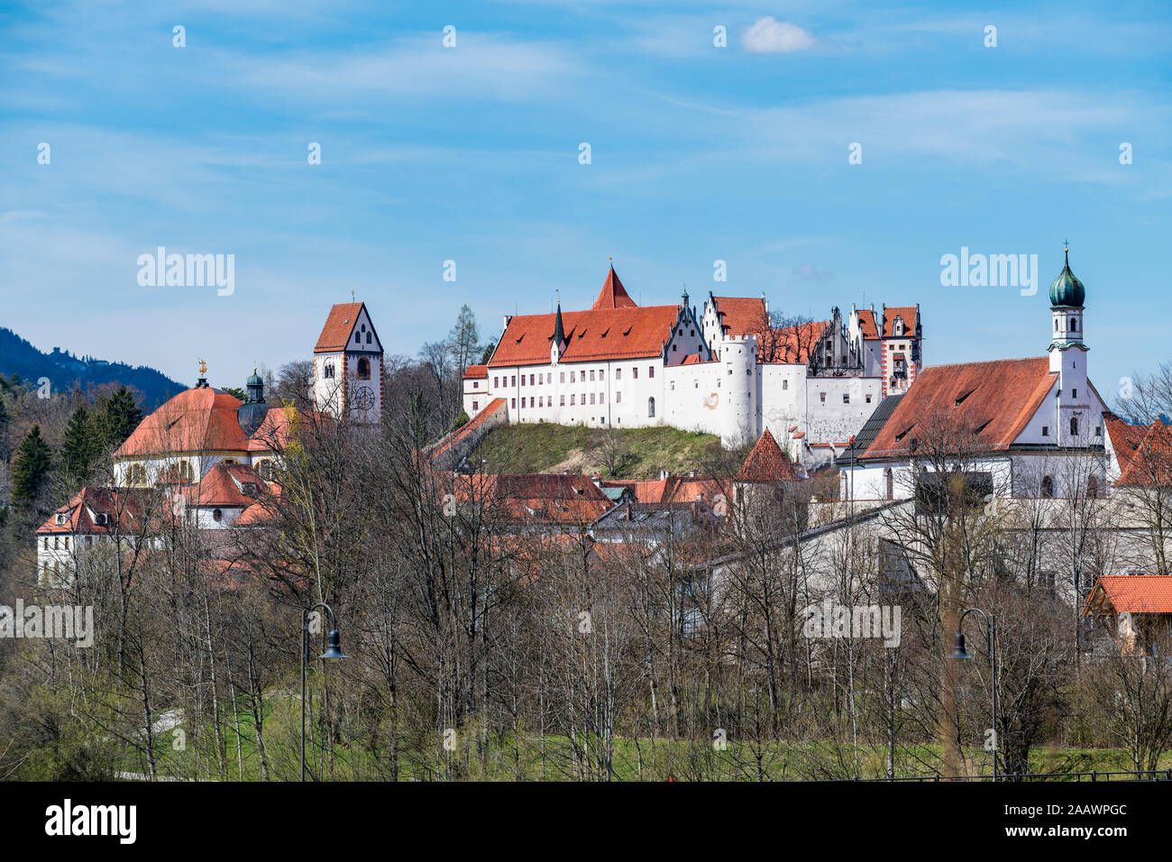 Germany, Bavaria, Fussen, Saint Mangs Abbey seen through trees Stock Photo