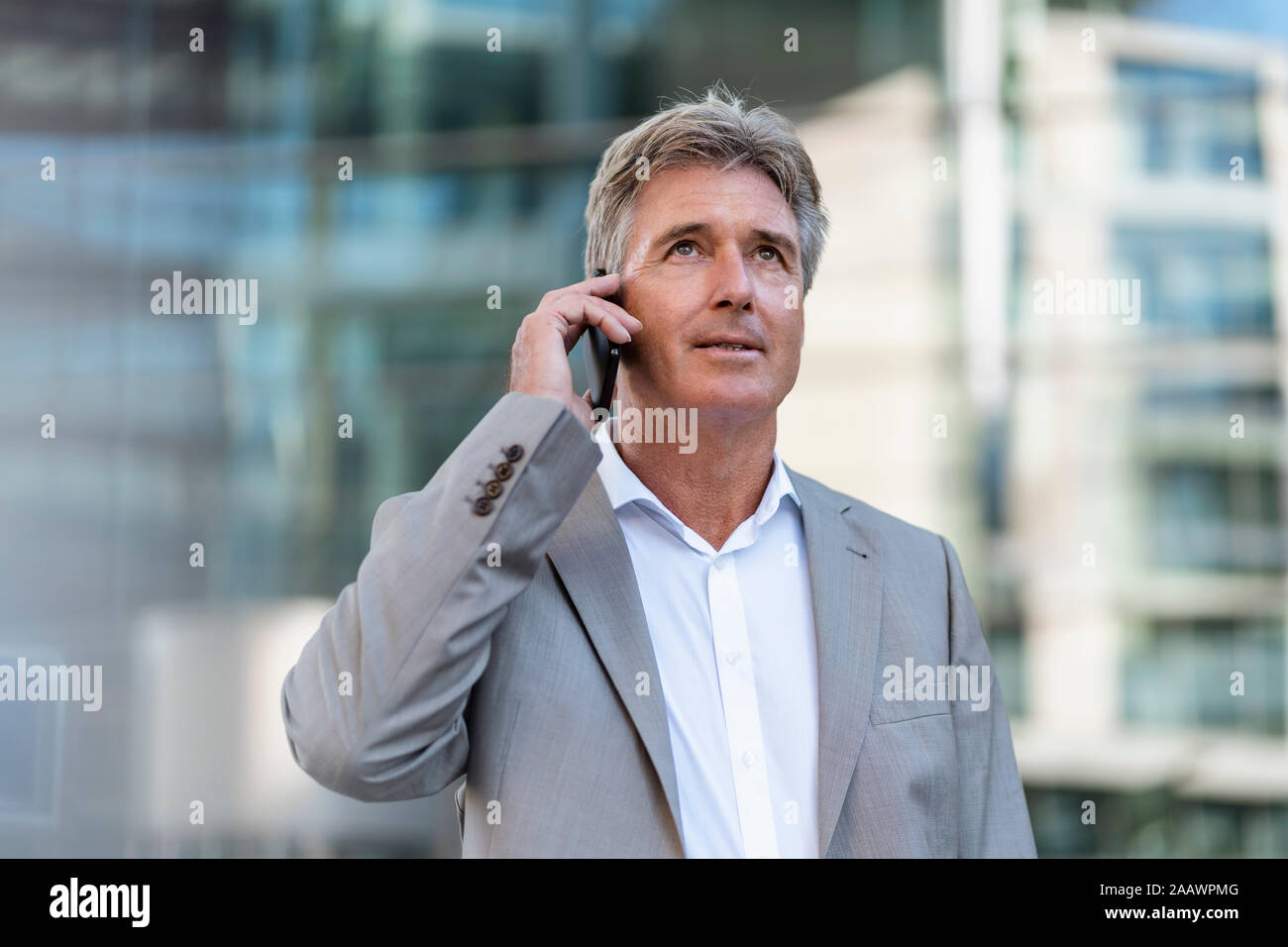 Mature businessman on the phone in the city Stock Photo