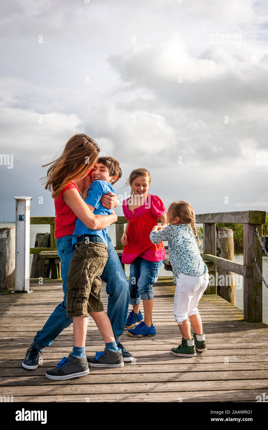 Happy family on a pier, Ahrenshoop, Mecklenburg-Western Pomerania, Germany Stock Photo